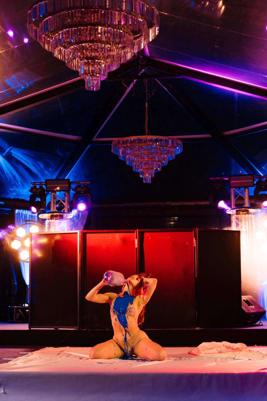 Dancer performing under crystal chandeliers